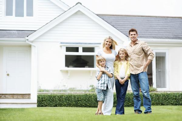 Homeowners in front of the home