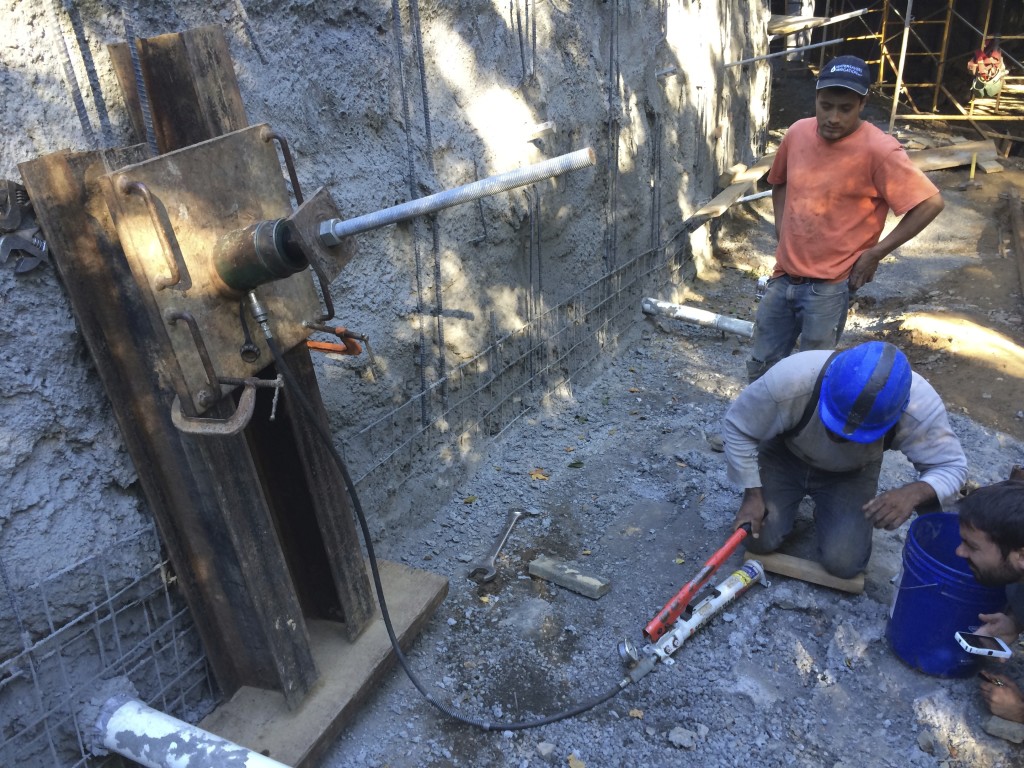 Pull testing helical tieback for pullout strength. You have to test the anchor to verify it will hold beyond working specifications. If the anchor moves, then it must be driven deeper into the ground.