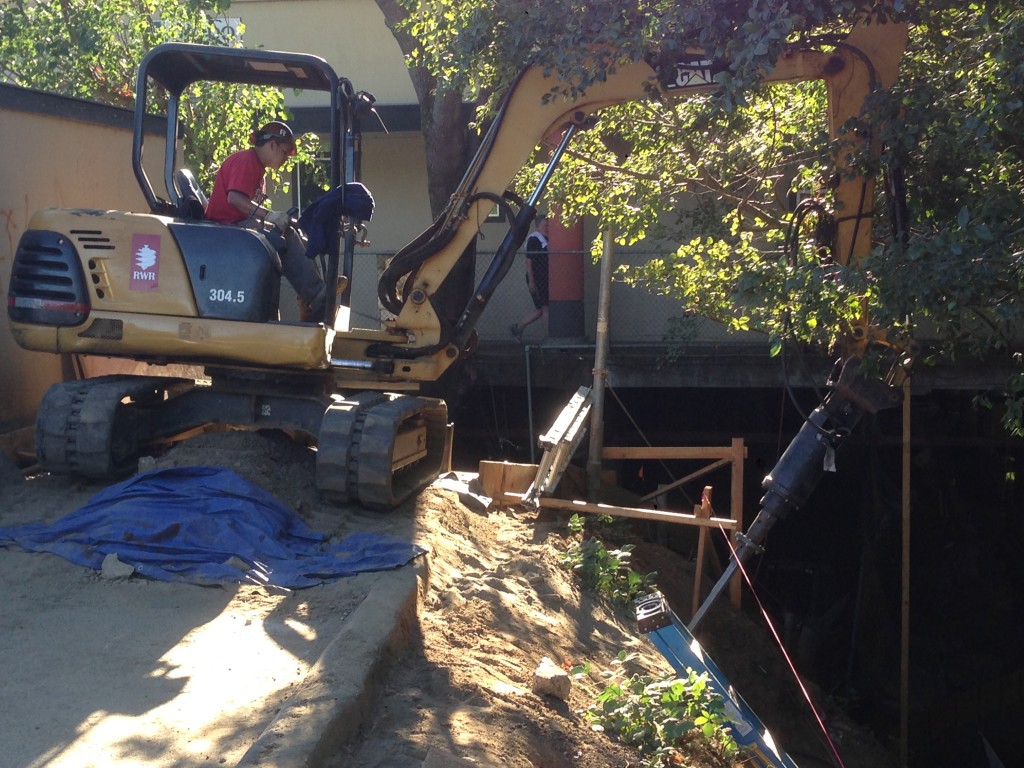 Installing helical anchor on creek bank