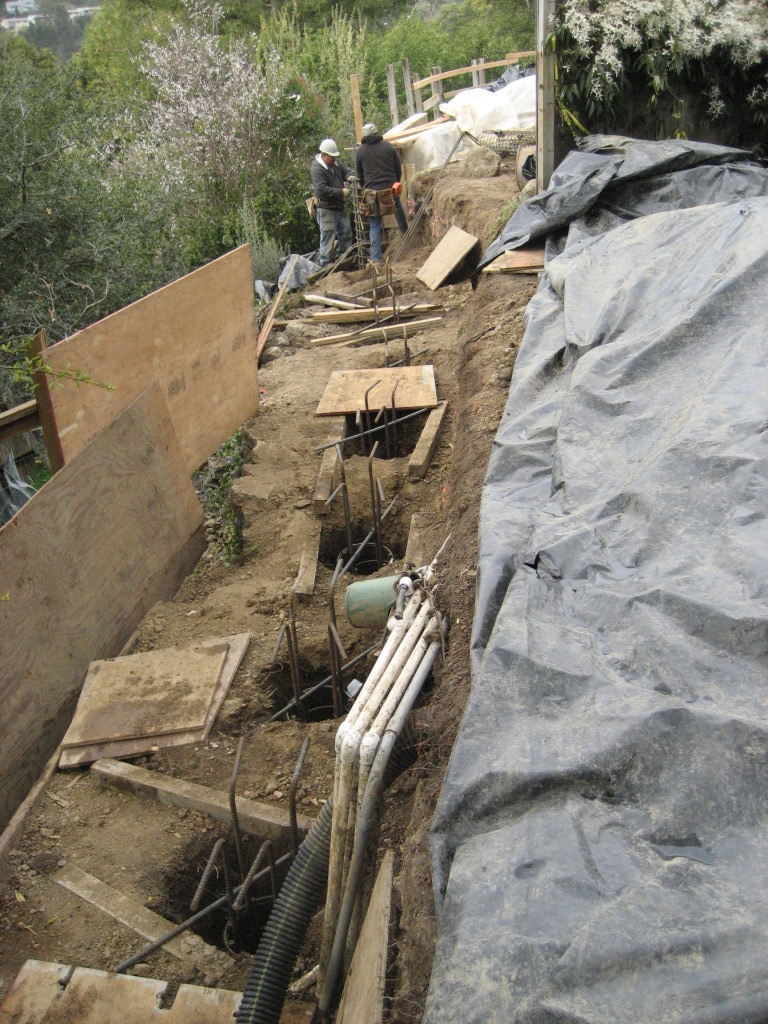 Stabilizing hillside with deep piers, ready to pour