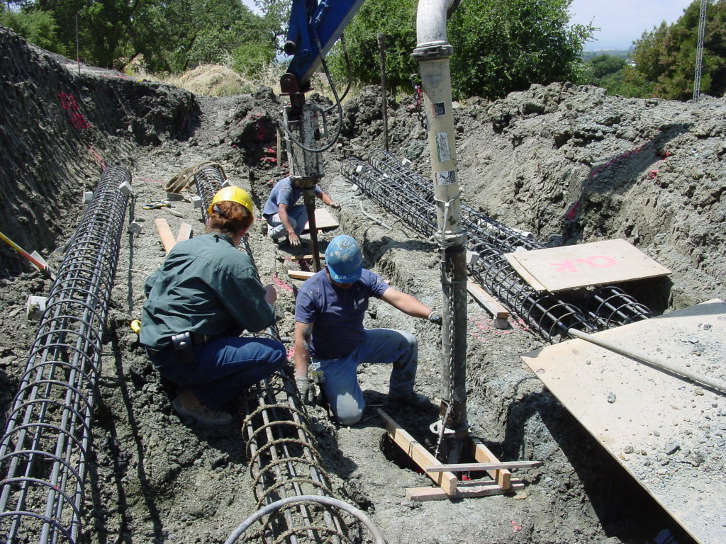 Pouring piers for landslide repair, with reinforcing cages shown on ground