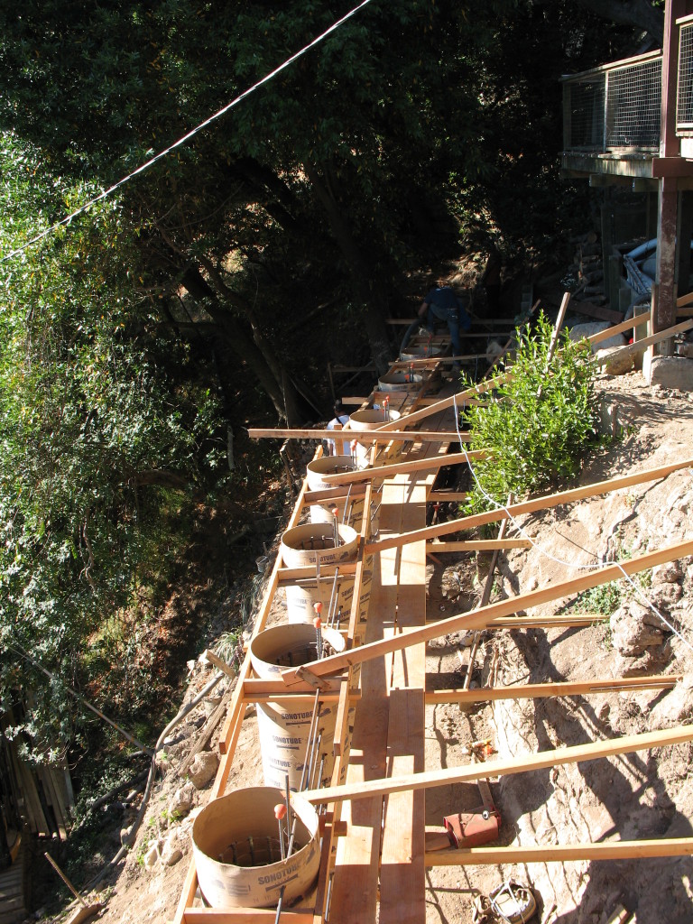Sonotube-formed piers for retaining wall
