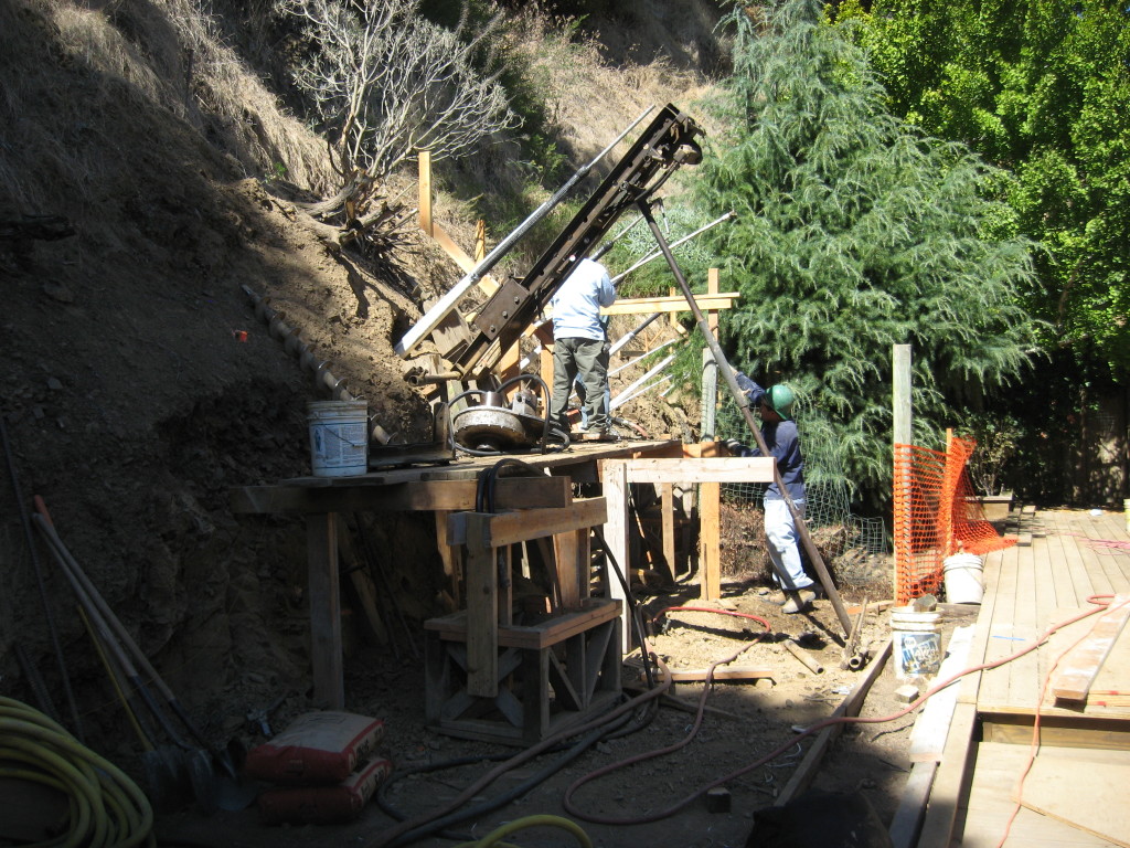 Drilling into hillside for tieback installation