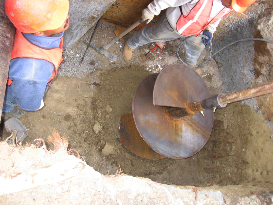 Auger drilling with track rig