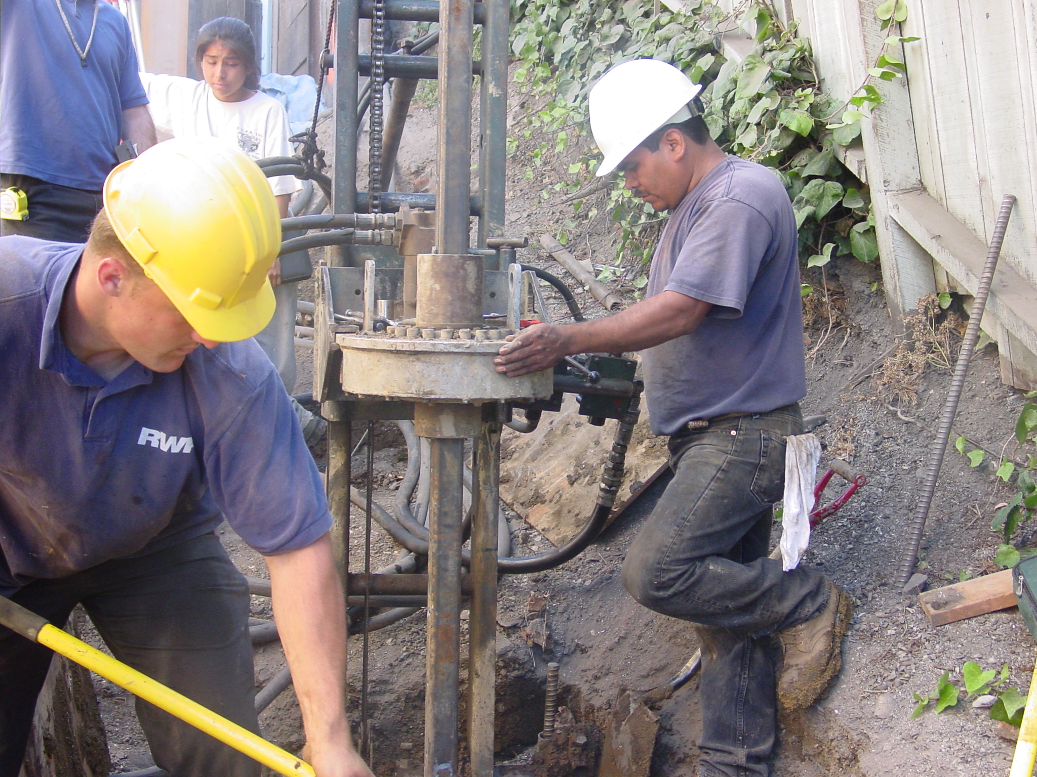 Pier drilling for retaining wall in back yard